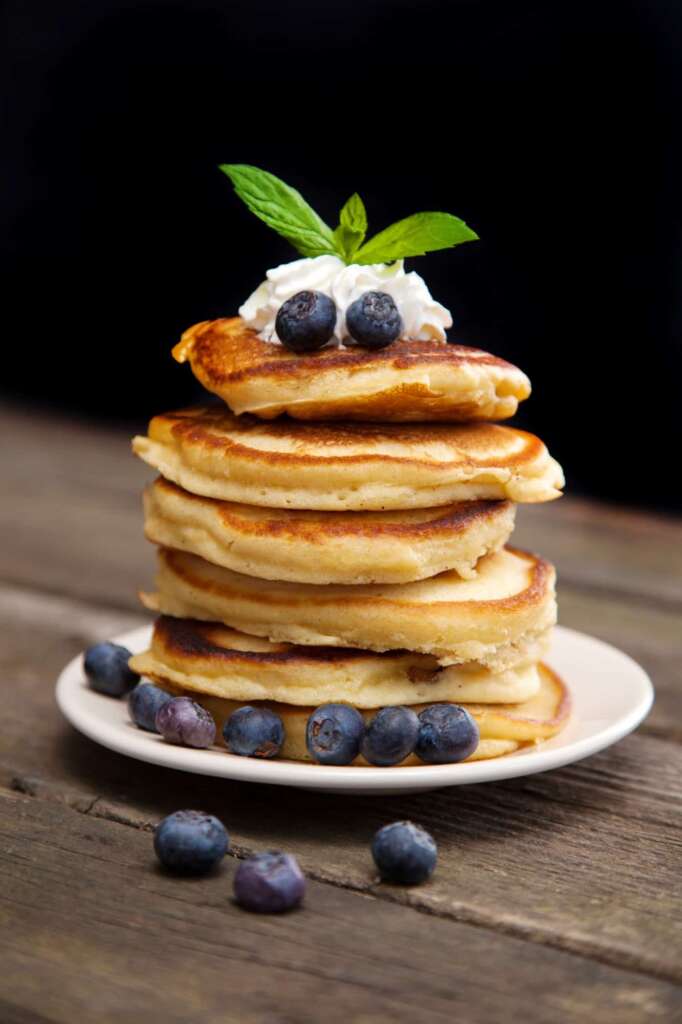 Delicious pancakes with blueberry, whipped cream and mint
